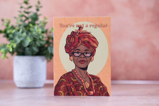 Card with illustration of a woman wearing glasses and a red dress, with text 'You're not a regular mom' on a pink background.
